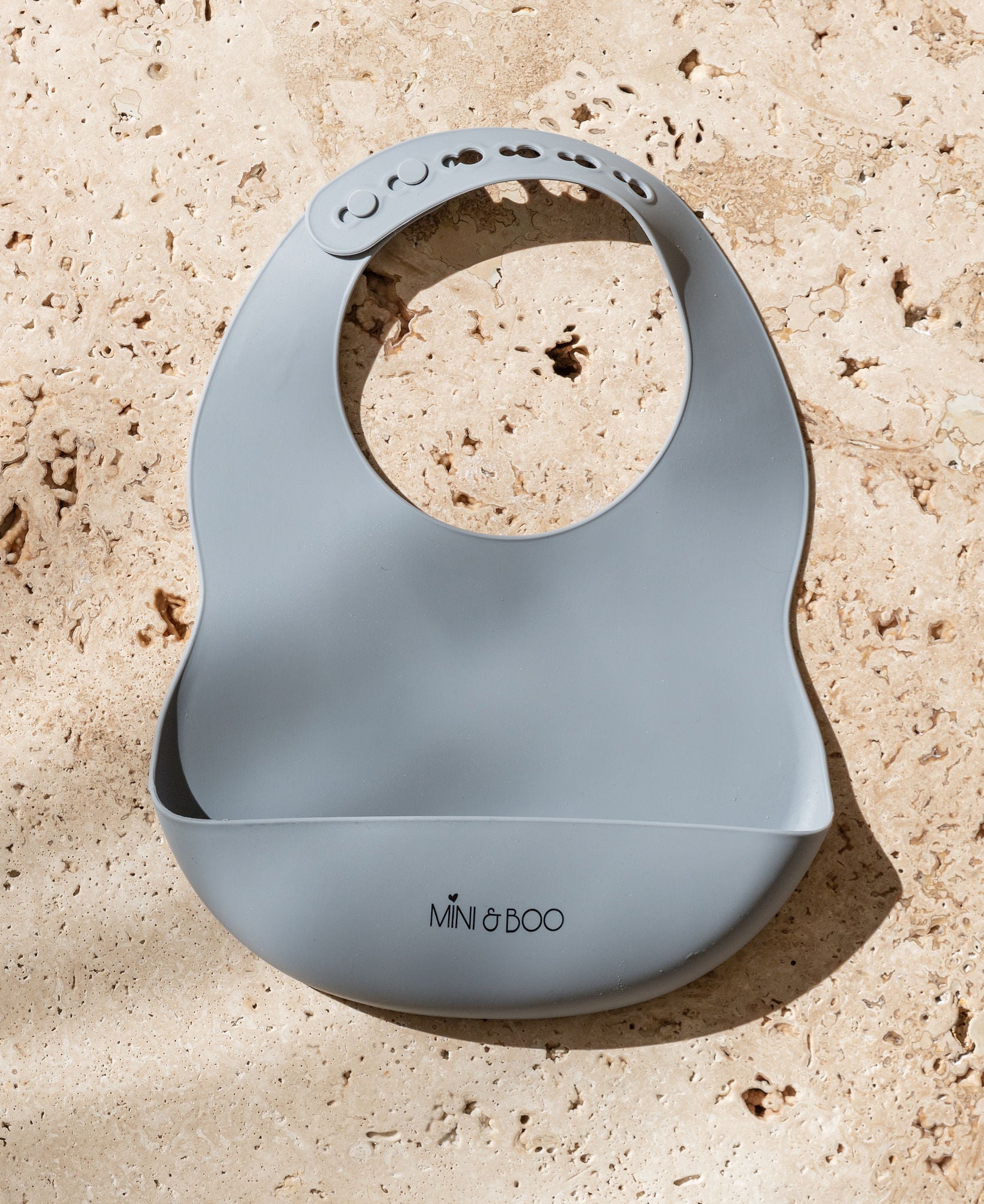 Mini and Boo silicone bib in pebble – adjustable neck, deep food catcher pocket, BPA-free, dishwasher-safe toddler feeding accessory.